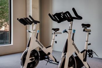 a group of white exercise bikes in a room at Marquee, Minneapolis, MN, 55403